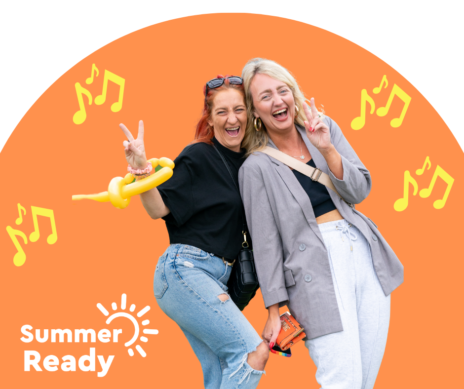 Trivallis Housing Landlord Wales Two women are posing and smiling with peace signs in front of an orange backdrop with musical notes. One wears a black top and ripped jeans while holding a balloon animal. The other wears a gray jacket over a black top and gray pants. The text reads 